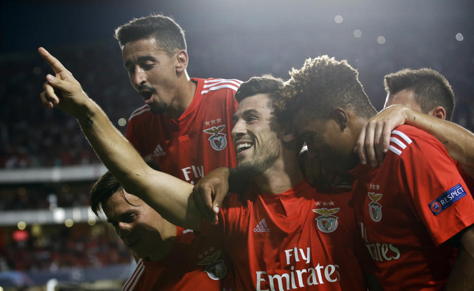 Benfica's Pizzi, center, celebrates scoring his side's first goal from a penalty kick during the Champions League playoffs, first leg, soccer match between Benfica and PAOK at the Luz stadium in Lisbon, Tuesday, Aug. 21, 2018. (AP Photo/Armando Franca)