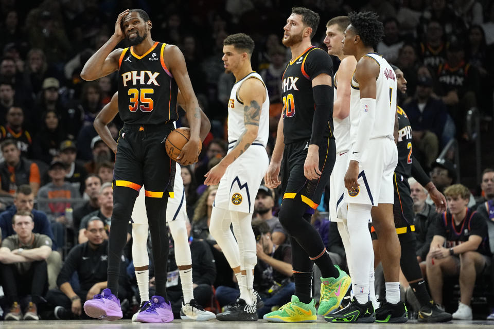 Phoenix Suns forward Kevin Durant (35) reacts after a foul during the second half of an NBA basketball game against the Denver Nuggets, Friday, Dec. 1, 2023, in Phoenix. (AP Photo/Matt York)