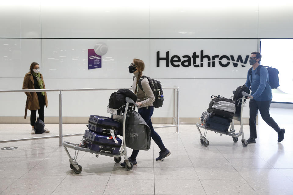 LONDON, ENGLAND - JANUARY 30: Travelers arrive at Heathrow Terminal 2 on January 30, 2021 in London, England. The UK government has added flights from the UAE to the 