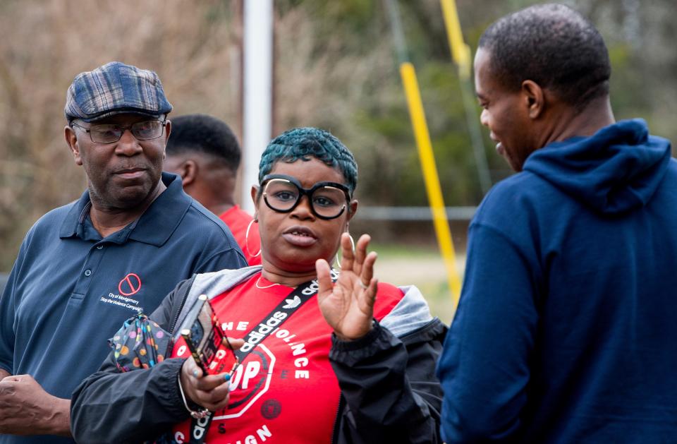 Community volunteers and leaders, including Ro Tyus Hollyfield, center, with the Montgomery city Office of Violence Prevention, take part in a Stop the Violence Walk in the North Pass Community in north Montgomery, Ala., on Saturday February 10, 2024.