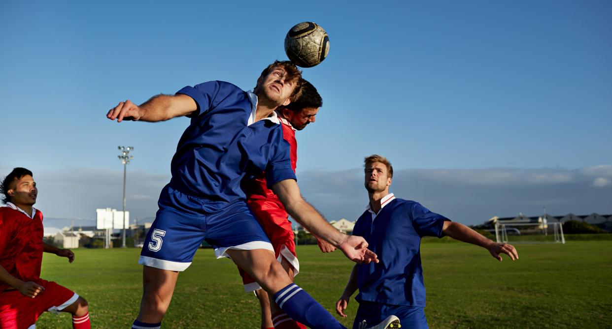 Man heads ball during football match as study finds that footballers are more at risk of dementia. (Getty Images)