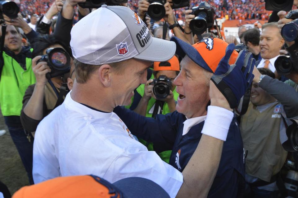 Denver Broncos quarterback Peyton Manning, left, celebrates with Denver Broncos head coach John Fox after the AFC Championship NFL playoff football game against the New England Patriots in Denver, Sunday, Jan. 19, 2014. The Broncos defeated the Patriots 26-16 to advance to the Super Bowl. (AP Photo/Jack Dempsey)