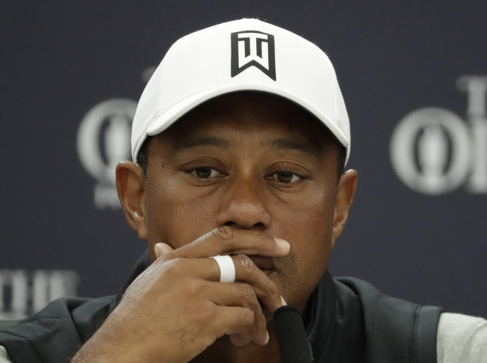 Tiger Woods of the United States listens to a question from the media during a press conference ahead of the start of the British Open golf championships at Royal Portrush in Northern Ireland, Tuesday, July 16, 2019. The British Open starts Thursday. (AP Photo/Matt Dunham)
