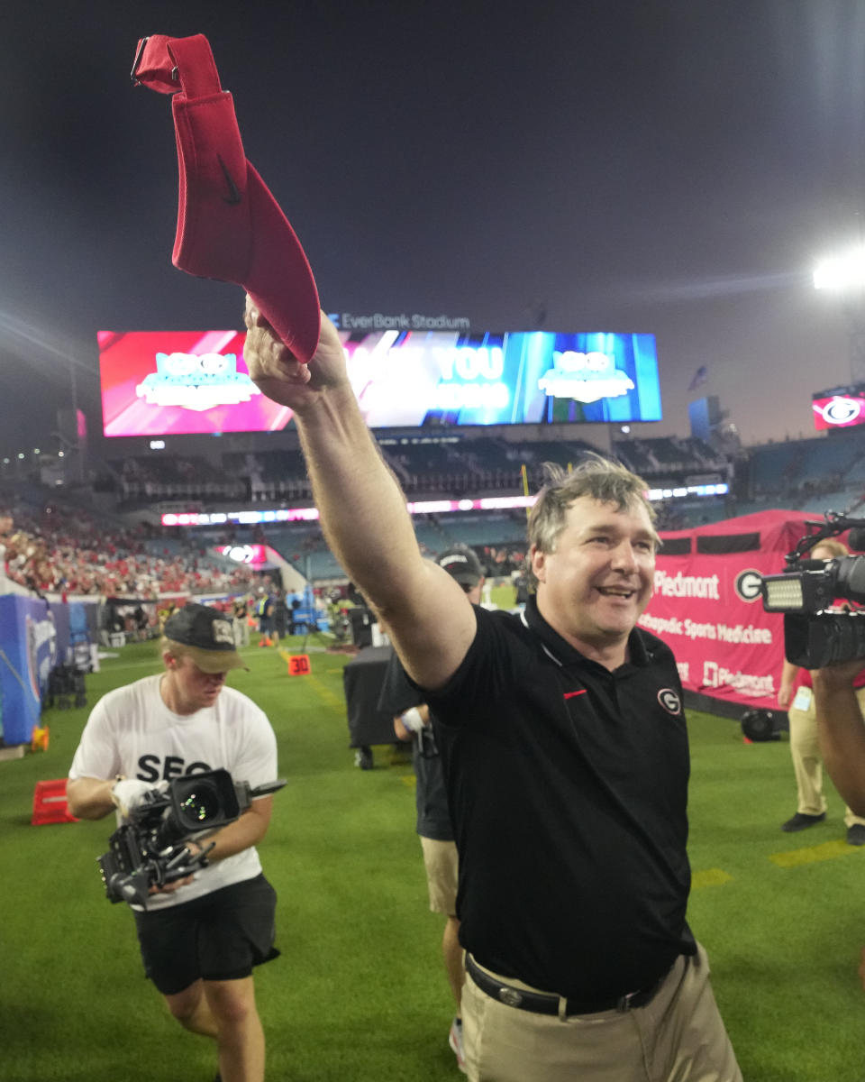 Georgia head coach Kirby Smart celebrates in front of fans as he runs off the field after defeating Florida in an NCAA college football game, Saturday, Oct. 28, 2023, in Jacksonville, Fla. (AP Photo/John Raoux)