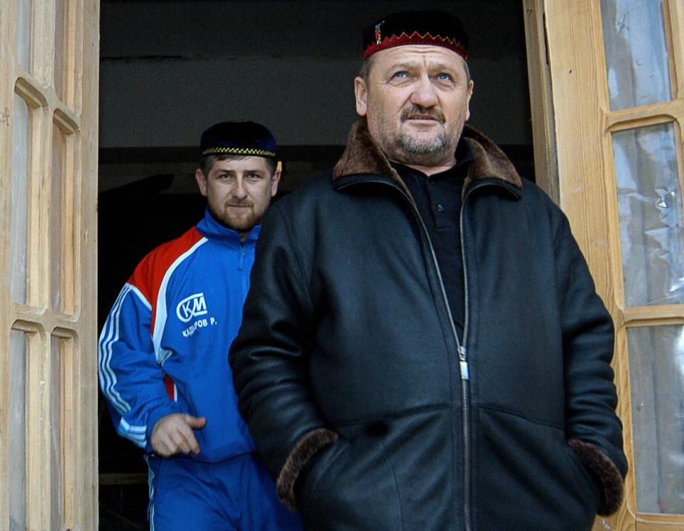 The archival photo shows Chechen leader Akhmad Kadyrov (R) and his son Ramzan standing in front of Ramzan's house in Tsentoroy, Kadyrov's native village, some 40 km from Chechen capital Grozny on Jan. 30, 2004. (Stringer /AFP via Getty Images)