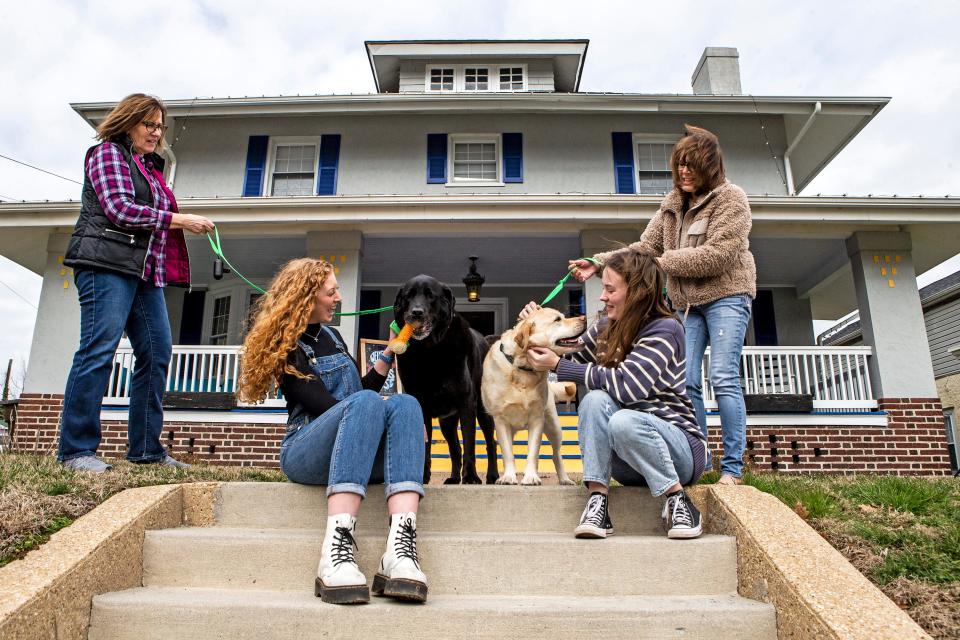 From left, Terry Grey, Allison Burns, therapy dogs Beau and Ellie, Kerry Mullins and Angela Foley are featured on the front steps of Sean's House, located just off the University of Delaware campus in Newark, Wednesday, March 1, 2023. Sean's House, in partnership with SL24: Unlocke the Light Foundation, has been providing a safe haven to address mental health concerns and provide resources for students of UD and beyond.