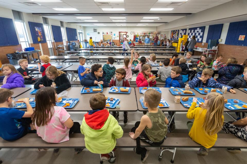 Students at Tecumseh South elementary school enjoy their school lunch of chili dogs, steamed carrots, applesauce and milk Thursday afternoon.