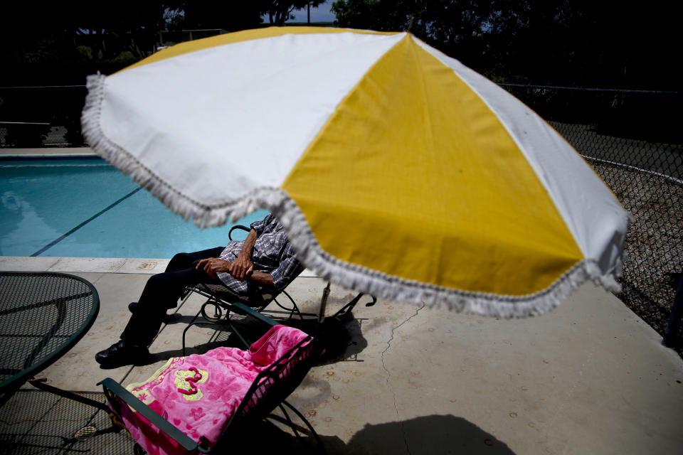 79-year-old Jack Waddington rests near the pool at the Santa Monica Village Trailer Park in Santa Monica, Calif., Tuesday, July 10, 2012. The city's Planning Commission recently recommended the 3.8-acre park's zoning be changed to allow a developer to bulldoze its modest, rent-controlled homes and replace them with nearly 200 much-higher-priced apartments and condominiums, as well as more than 100,000 square feet of office and retail space. (AP Photo/Jae C. Hong)