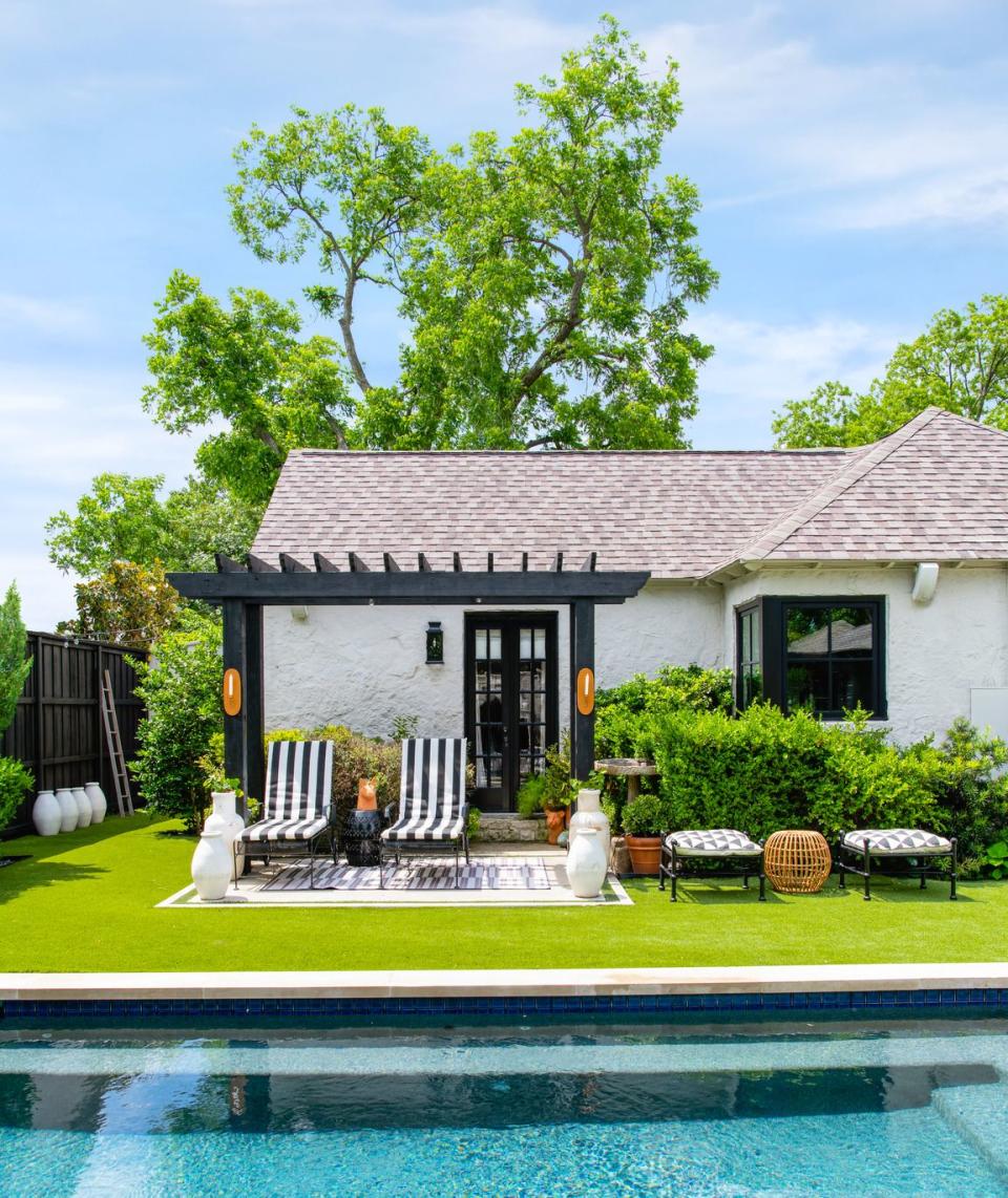 1930's cottage designed by burkle creative side patio vintage doors open to the pool from the primary suite chairs vintage, in pindler sunbrella fabric rugs serena lily benches and pouf world market candleholders from mexico