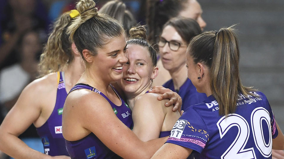 The Queensland Firebirds are pictured celebrating after a win in the Suncorp Super Netball competition.