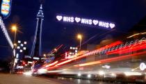 Cars pass under a tribute to Britain's NHS (National Health Service) as part of the Illuminations in Blackpool