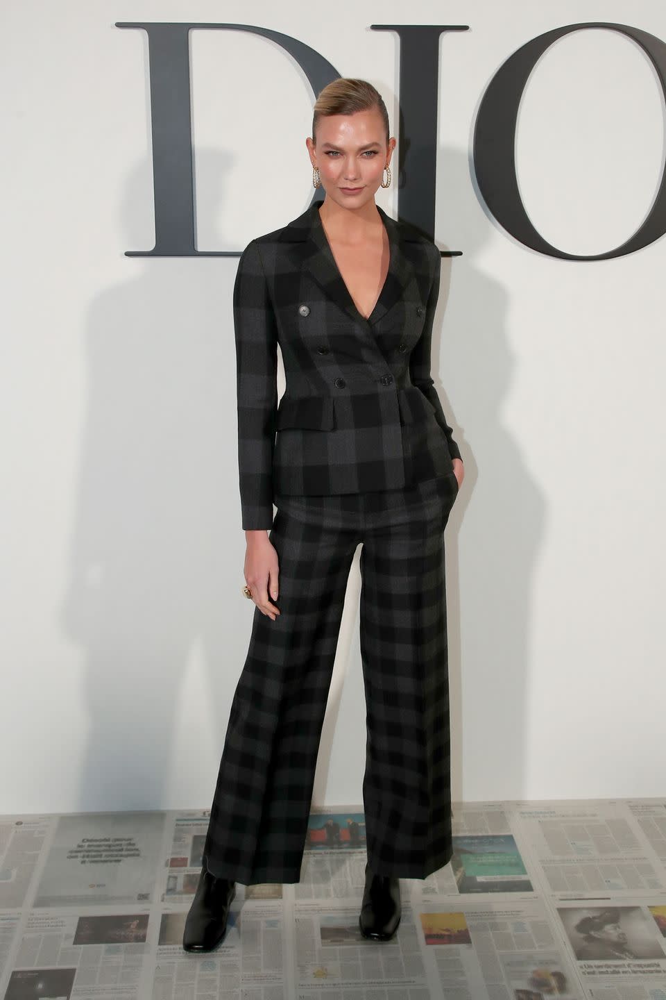 <p>Karlie Kloss added an edge to her trouser suit with square-toe boots. </p>