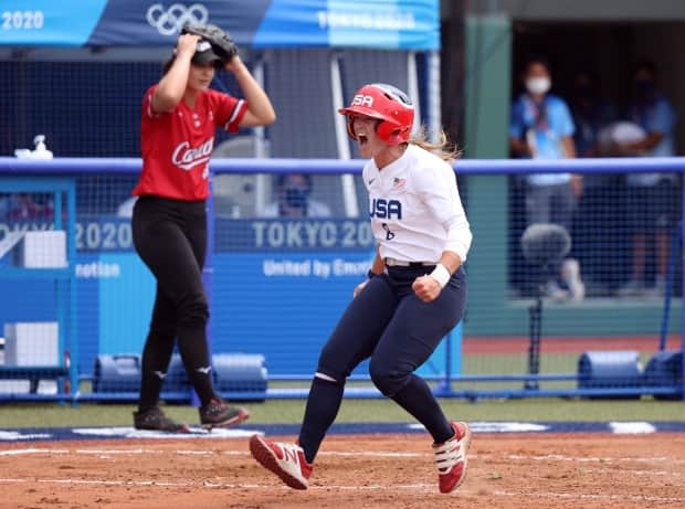 Canadian pitcher Jenna Caira, left, reacts after the U.S. scores during her team's 1-0 loss on Wednesday in the opening round of the 2020 Tokyo Olympic Games. (Yuichi Masuda/Getty Images - image credit)