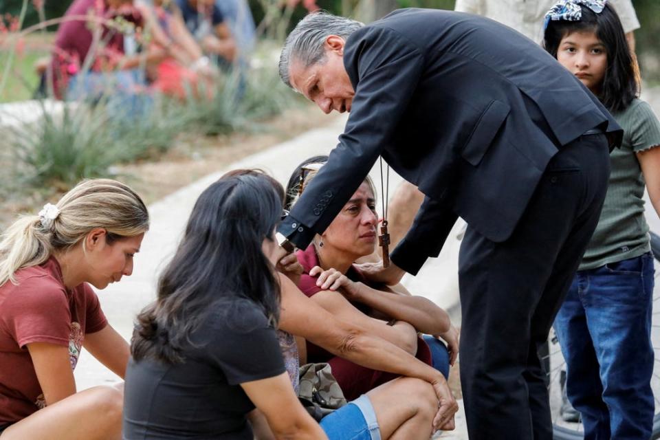 Gustavo Garcia-Siller, Archbishop of the Archdiocese of San Antonio, comforts people as they react outside the Ssgt Willie de Leon Civic Center, where students had been transported from Robb Elementary School after a shooting, in Uvalde, Texas, US on 24 May 2022 (Reuters)