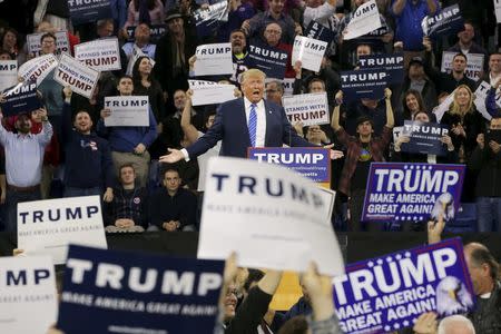 Audience members react as U.S. Republican presidential candidate Donald Trump speaks at a campaign rally in Lowell, Massachusetts January 4, 2016. REUTERS/Brian Snyder