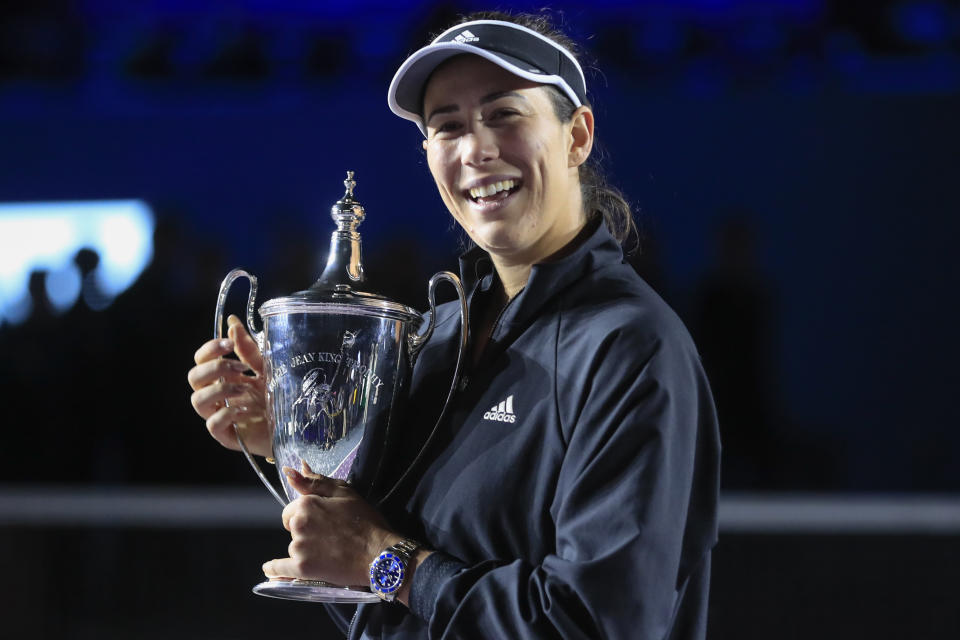 Garbiñe Muguruza, of Spain, holds the trophy during an awarding ceremony after defeating Anett Kontaveit, of Estonia, at the final match of the WTA Finals tennis tournament in Guadalajara, Mexico, Wednesday, Nov. 17, 2021. (AP Photo/Refugio Ruiz)