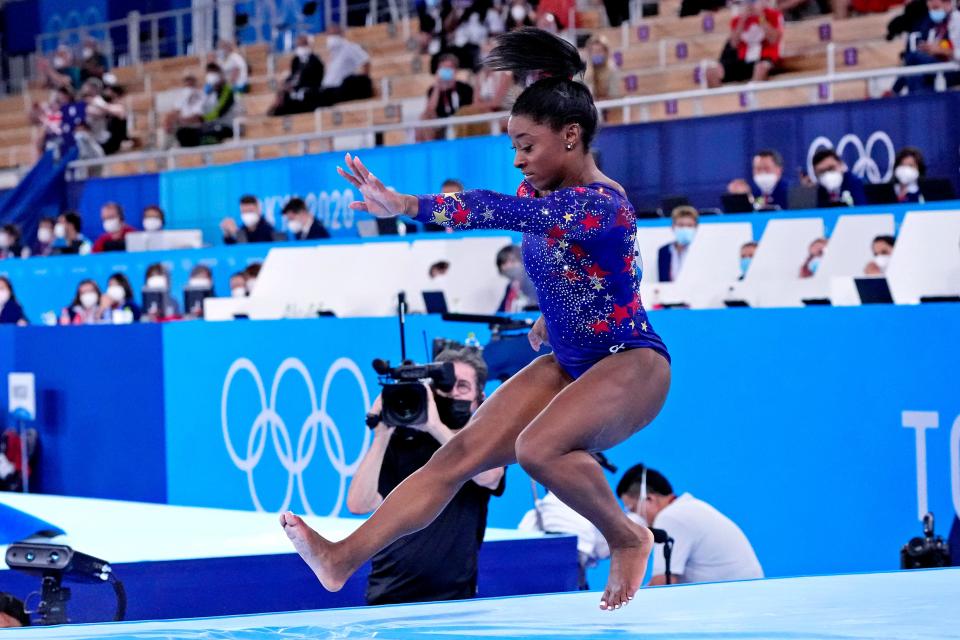 Simone Biles stumbles on her dismount on balance beam during team qualifying.