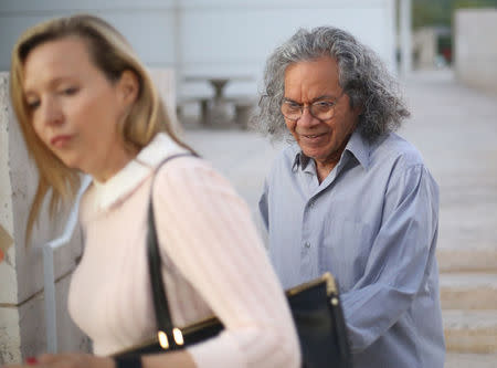The billionaire founder of Insys Therapeutics Inc. John Kapoor, exits the federal court house with an unidentified woman after a bail hearing in Phoenix, Arizona , U.S., October 27, 2017. REUTERS/Conor Ralph