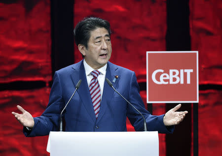 Japanese Prime Minister Shinzo Abe speaks during the opening ceremony of the CeBit computer fair, which will open its doors to the public on March 20, at the fairground in Hanover, Germany, March 19, 2017. REUTERS/Fabian Bimmer