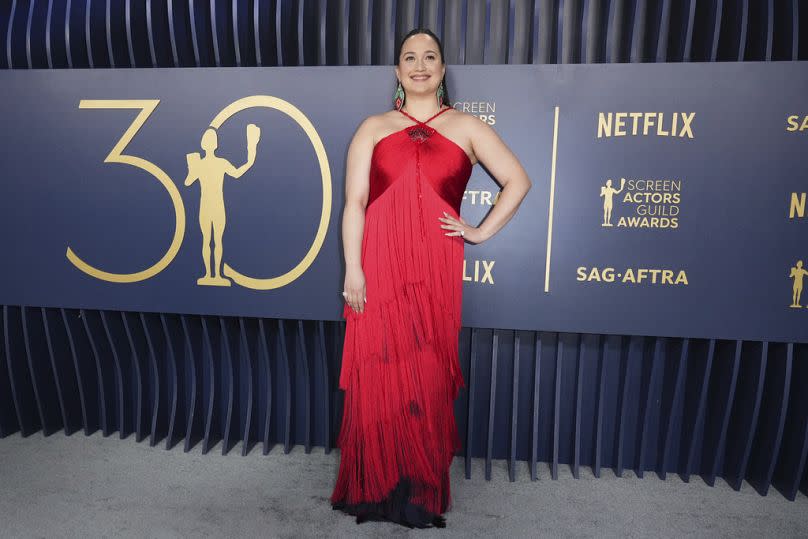 Lily Gladstone, winner of the SAG Award for best female performance in a drama film, in a shimmery red gown from Georgio Armani.