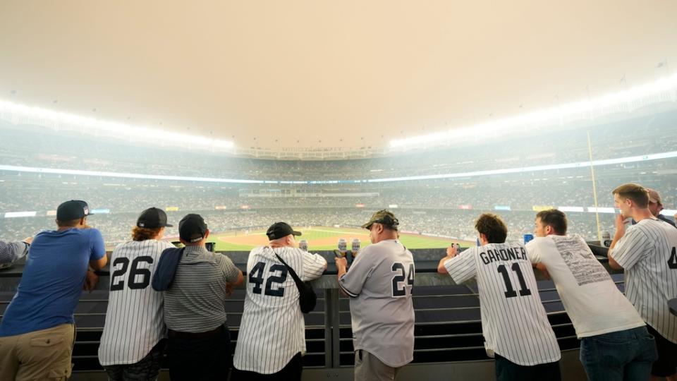 Yankee fans watch the game against the White Sox as a thick haze from the Canadian wildfires hover over The Bronx. Tuesday, June 6, 2023