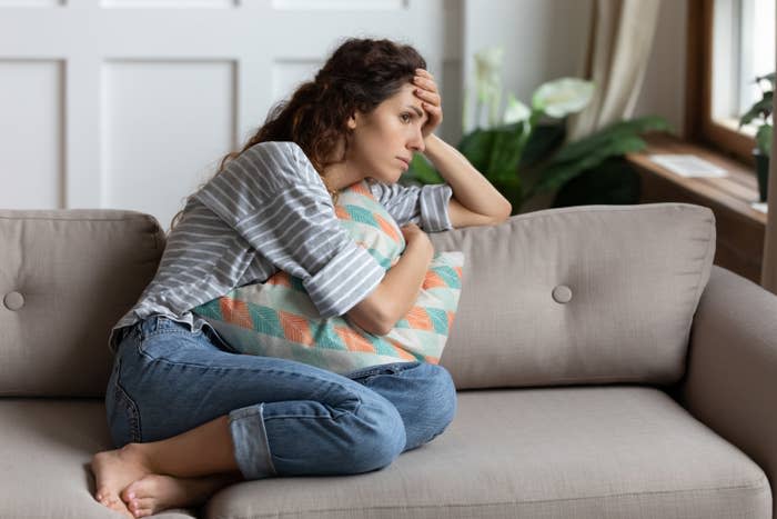 a woman looking anxious on the couch