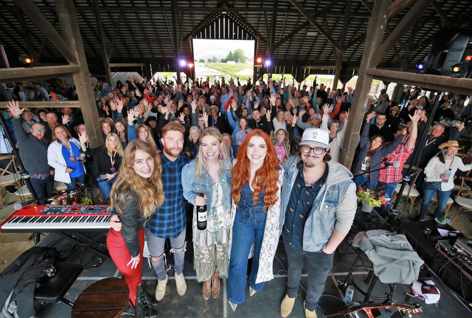 Ingrid Andress, Chris Lane, Marley Sherwood of CMT, Caylee Hammack and HARDY strike a pose with the crowd at Round Pond Estate on May 15. 