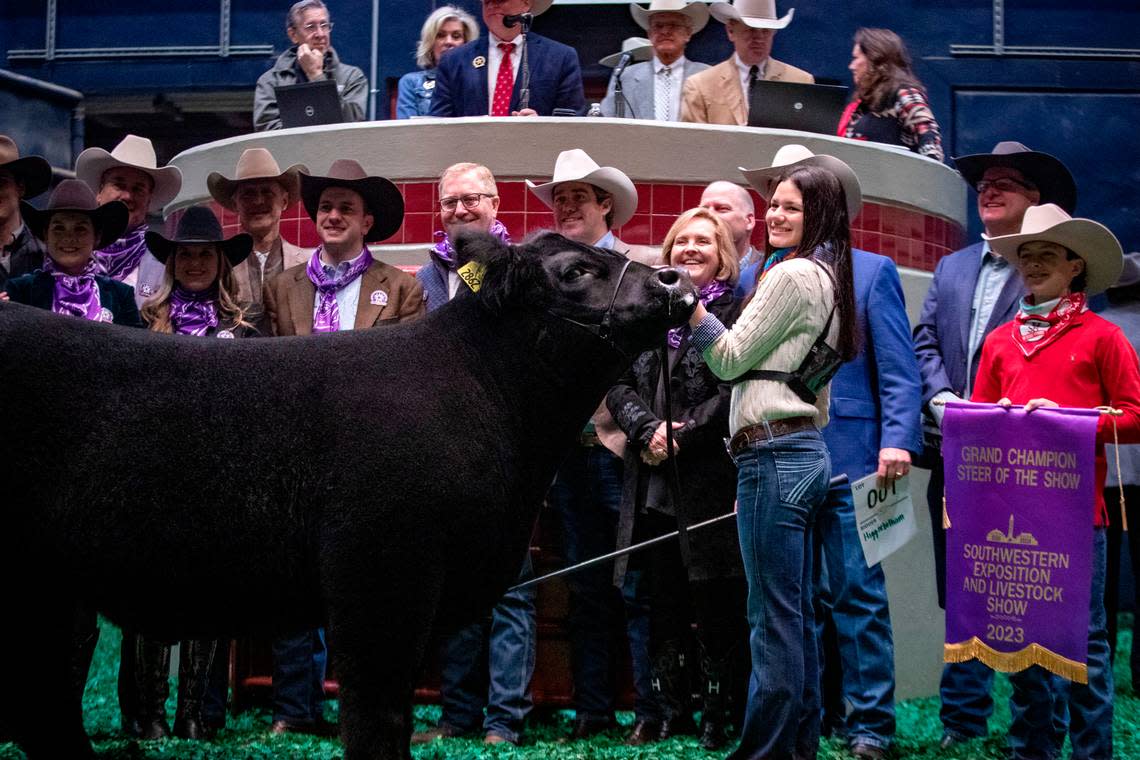 Sadie Wampler stands with buyers after her 2023 Grand Champion steer was auctioned during the Fort Worth Stock Show & Rodeo’s Junior Sale of Champions on Saturday, Feb. 4, 2023. Wampler’s steer was sold for $440,000, beating last year’s record by $130,000.