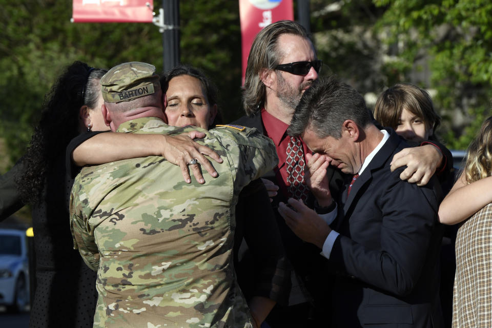 Natalie Henry-Howell, second from left, and Thomas Howell, right, parents of Riley Howell, are comforted after a memorial service for Riley Howell in Lake Junaluska, N.C., Sunday, May 5, 2019. Family and hundreds of friends and neighbors are remembering Howell, a North Carolina college student credited with saving classmates' lives by rushing a gunman firing inside their lecture hall. (AP Photo/Kathy Kmonicek)