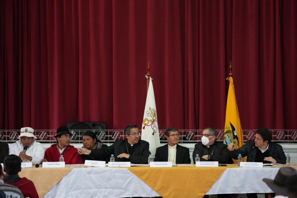 Government representative Francisco Jimenez, far right, and Indigenous leaders, from left, Eustaquio Toala, Leonidas Iza and Marlon Vargas, sit on opposite sides of Catholic Church representatives during a dialogue session at the Episcopal Conference headquarters in Quito, Ecuador, Thursday, June 30, 2022. The two groups are discussing solutions that could lead to the end of a strike over gas prices that has paralyzed parts of the country for two weeks. Church leaders are, from left, Monsignors David de la Torre, Luis Cabrera, and Alfredo Espinoza. (AP Photo/Dolores Ochoa)