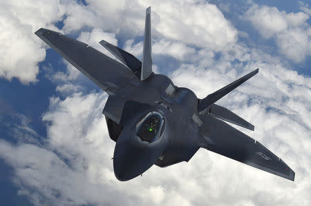 FILE PHOTO: A U.S. F-22 Raptor fighter flies over European airspace during a flight to Britain from Mihail Kogalniceanu air base in Romania April 25, 2016. REUTERS/Toby Melville/File Photo