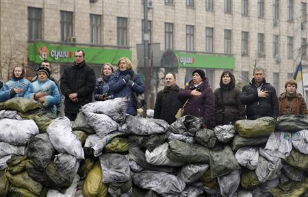 People sing the Ukrainian national anthem at the barricades in Kiev February 10, 2014. REUTERS/David Mdzinarishvili