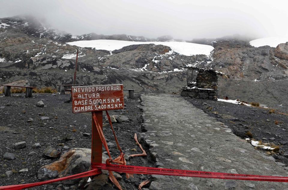 A sign shows the altitudes of the Pastoruri montain and glacier, while red tape prohibits closer access, along the Climate Change Route in Huaraz