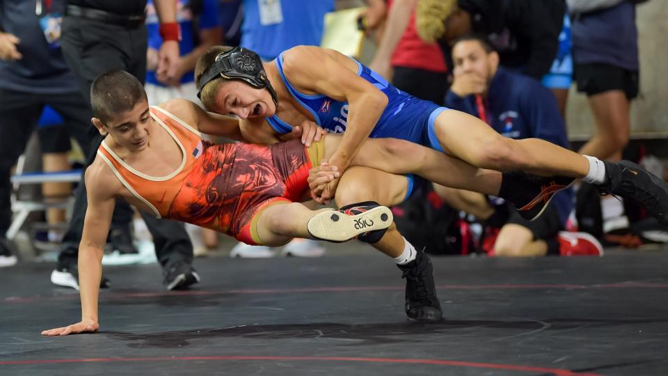 Perry's Lincoln Rohr (right) takes down California's Henry Aslikyan en route to a round of 16 win at the 16U Freestyle National Championships in Fargo, N.D.