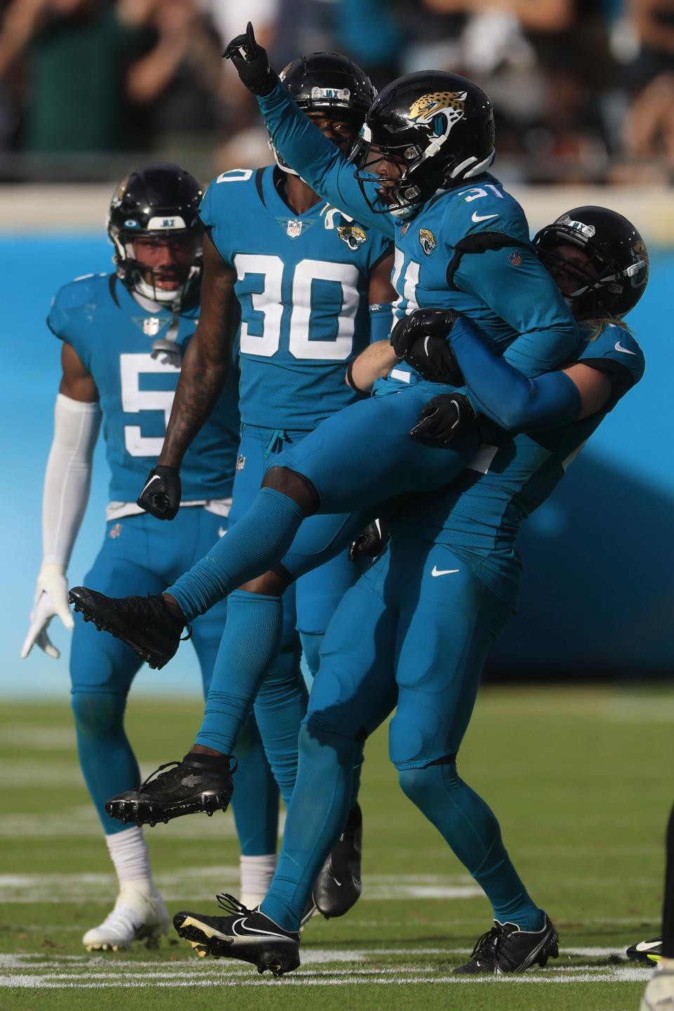 Jacksonville Jaguars cornerback Darious Williams (31) is congratulated by safety Andrew Wingard (42) after breaking up a pass play on 4th down as cornerback Montaric Brown (30) and Jacksonville Jaguars safety Andre Cisco (5) look on during the fourth quarter of a regular season NFL football matchup Sunday, Nov. 6, 2022 at TIAA Bank Field in Jacksonville. The Jacksonville Jaguars held off the Las Vegas Raiders 27-20. [Corey Perrine/Florida Times-Union]