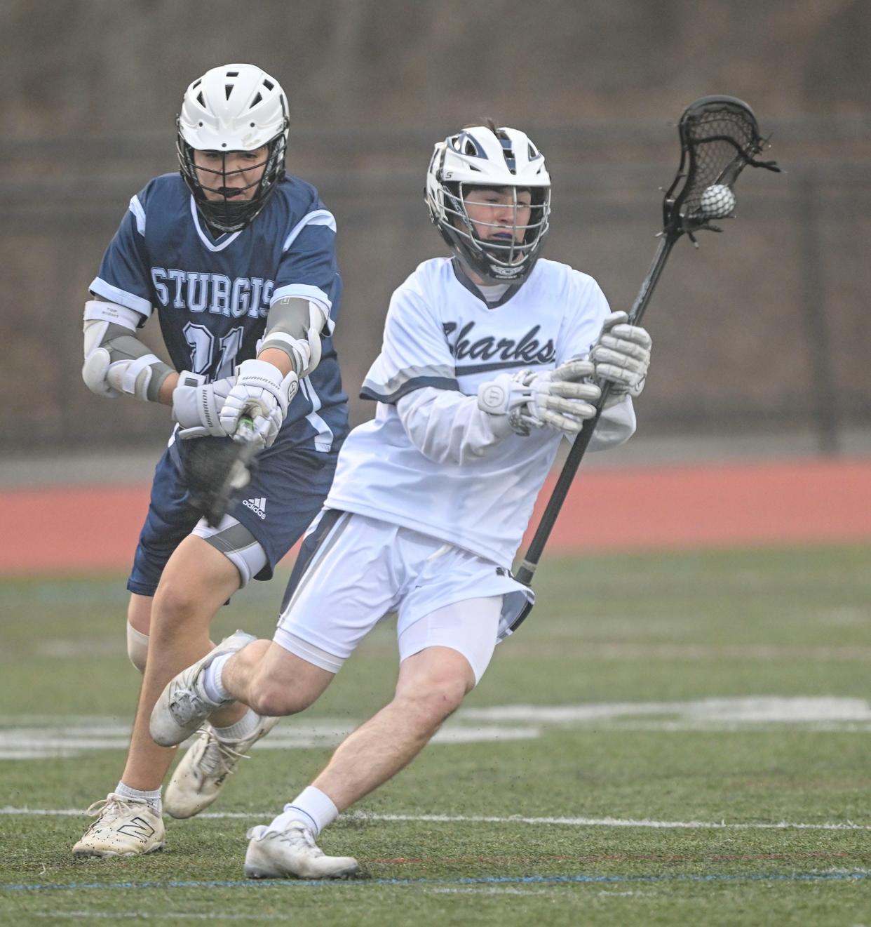 HARWICH 04/11/24 Tamer Khalil of Monomoy races past Kyle Sheppard of Sturgis East. boys lacrosse
Ron Schloerb/Cape Cod Times