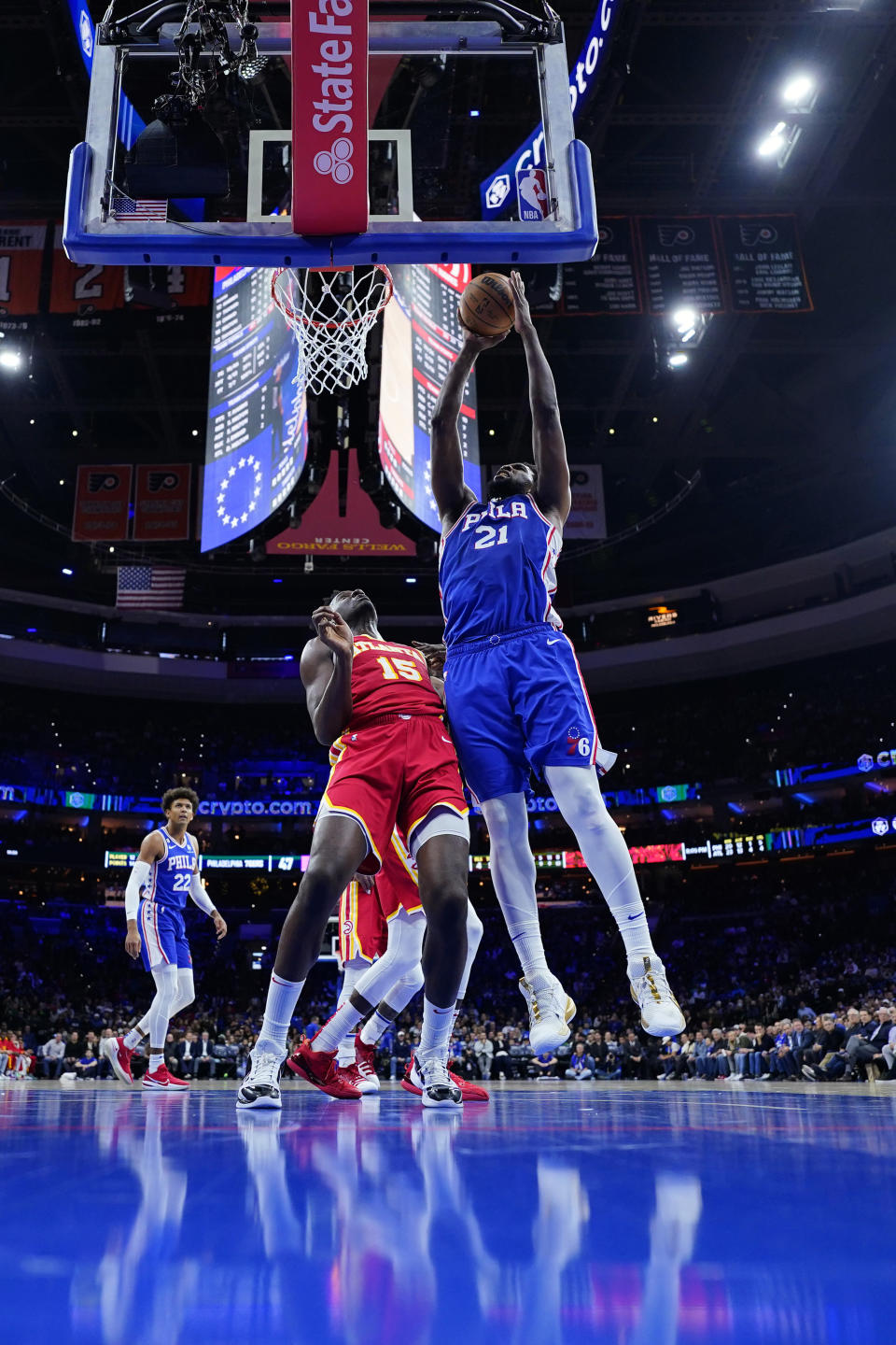 Philadelphia 76ers' Joel Embiid, right, goes up for a shot against Atlanta Hawks' Clint Capela during the first half of an NBA basketball game, Monday, Nov. 28, 2022, in Philadelphia. (AP Photo/Matt Slocum)