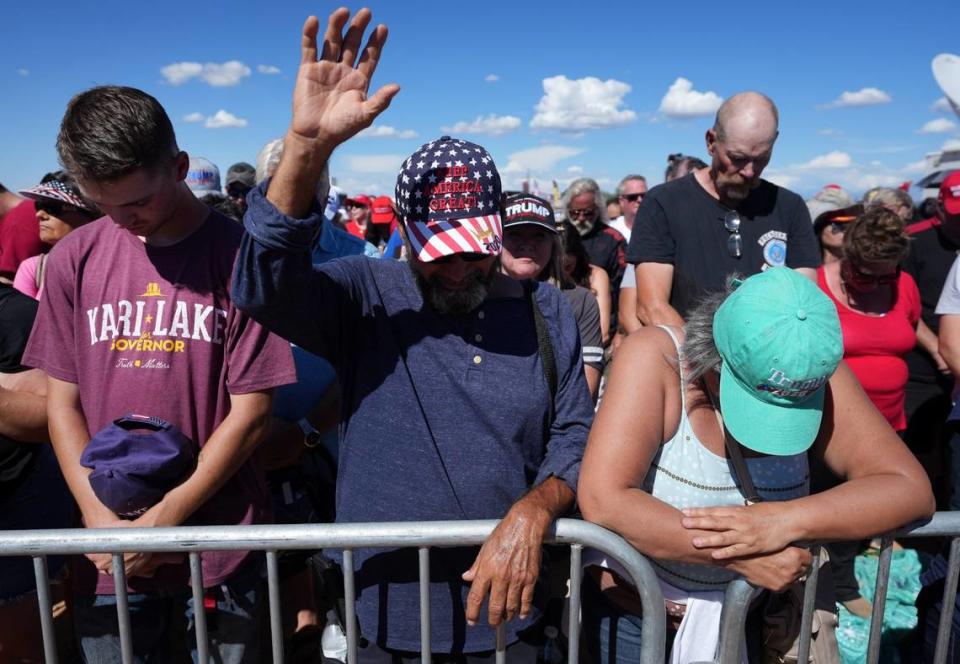 People gather in prayer at Legacy Sports Park in Mesa, Arizona, on Oct. 9, 2022, before a speech by former President Donald Trump.