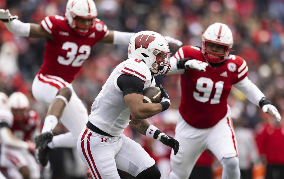 Wisconsin's Braelon Allen, center, carries the ball against Nebraska during the first half of an NCAA college football game Saturday, Nov. 19, 2022, in Lincoln, Neb. (AP Photo/Rebecca S. Gratz)