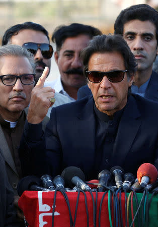 Imran Khan, chairman of the Pakistan Tehreek-e-Insaf (PTI) political party, gestures as he addresses to members of the media, after Pakistan's Supreme Court dismissed a petition to disqualify him from parliament for not declaring assets, outside Jinnah International Airport in Karachi, Pakistan December 15, 2017. REUTERS/Akhtar Soomro