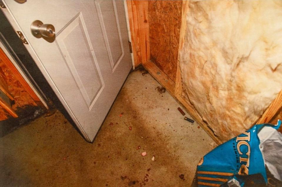 Crime scene photos show shell casings on the floor of the dog feed house (Law & Crime)