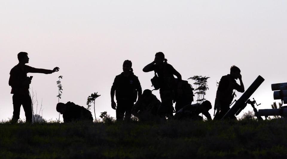 Nov. 2, Tel Tamir, Syria: Kurdish YPG soldiers fight Turkish forces on a road near the frontline. (Photo: Carol Guzy/Zuma Wire)