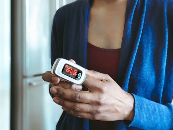 PHOTO: Close-up of woman using pulse oximeter to measure blood oxygen saturation level and heart rate. (STOCK PHOTO/Getty Images)