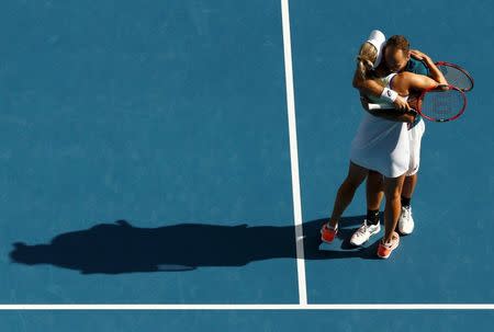 Russia's Elena Vesnina and Brazil's Bruno Soares celebrate after winning their mixed doubles final at the Australian Open tennis tournament at Melbourne Park, Australia, January 31, 2016. REUTERS/Jason Reed