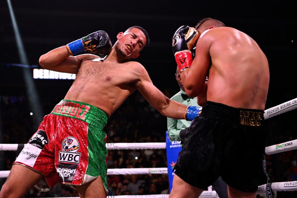 David Benavidez (right) throws a left at David Lemieux during their WBC Super Middleweight Interim Title fight at Gila River Arena on May 21, 2022, in Glendale, Arizona.