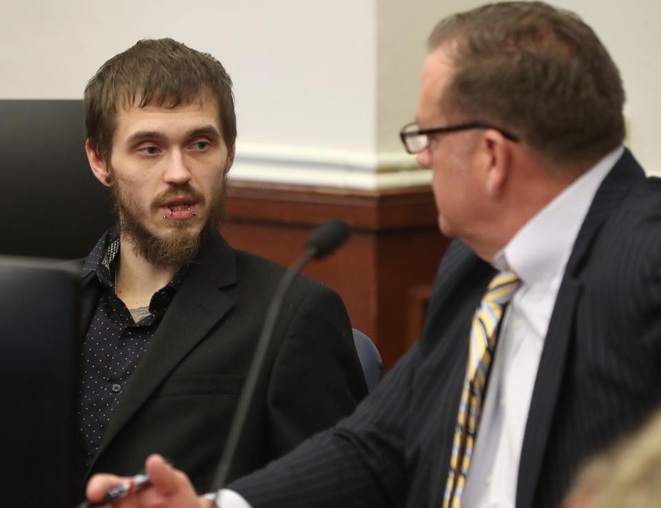 Brandon Mackey, left, talks to his attorney, Troy Reeves, during his sentencing in December in Summit County Common Pleas Court.