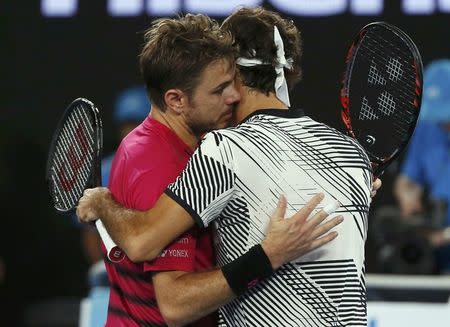 Tennis - Australian Open - Melbourne Park, Melbourne, Australia - 26/1/17 Switzerland's Roger Federer embraces Switzerland's Stan Wawrinka after winning his Men's singles semi-final match. REUTERS/Issei Kato