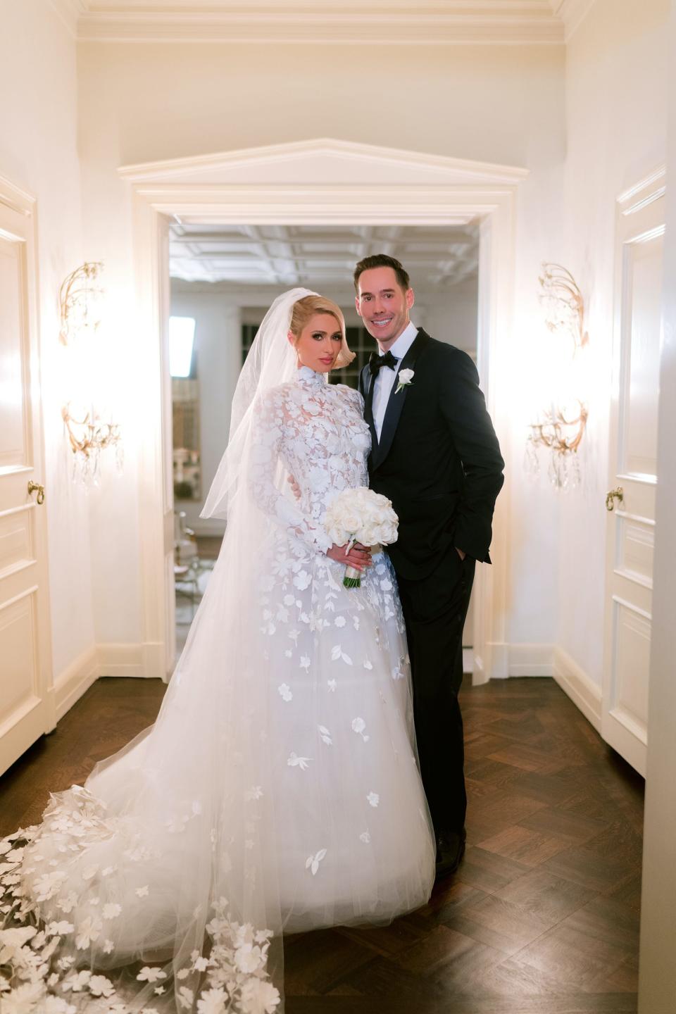 Paris Hilton and Carter Reum pose in their wedding attire.