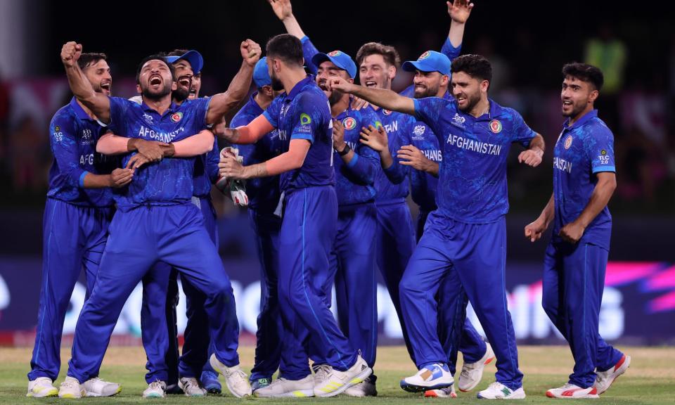 <span>Afghanistan players celebrate after beating <a class="link " href="https://sports.yahoo.com/soccer/teams/australia-women/" data-i13n="sec:content-canvas;subsec:anchor_text;elm:context_link" data-ylk="slk:Australia;sec:content-canvas;subsec:anchor_text;elm:context_link;itc:0">Australia</a> in the T20 World Cup at Arnos Vale Ground in St Vincent, Saint Vincent and The Grenadines.</span><span>Photograph: Darrian Traynor-ICC/ICC/Getty Images</span>