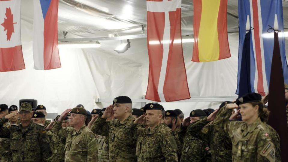 Soldiers of the NATO's multinational EFP battlegroup in Latvia attend the ceremony at the Adazi Military base, Latvia, 03 July 202